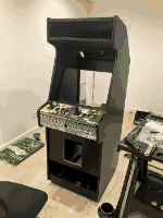 El mueble arcade en pleno montaje, con herramientas alrededor.
